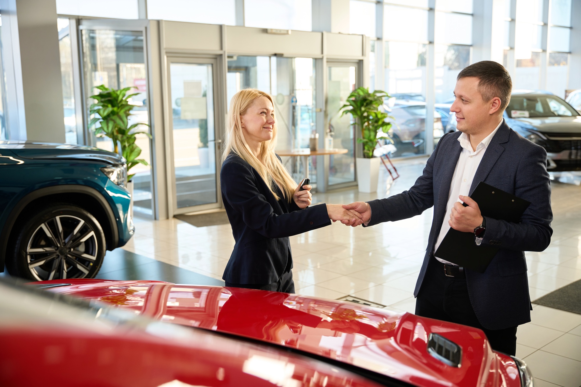 Sales manager shaking hand of young lady
